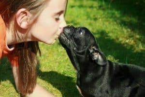 girl kissing dog