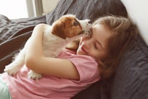 girl hugging dog