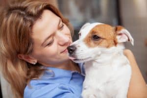 woman kissing dog