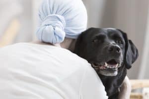 dog hugging patient