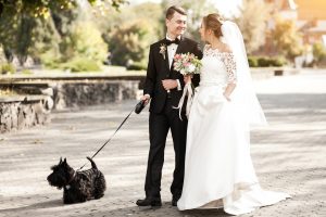 couple walking black dog