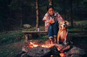 woman and dog campfire