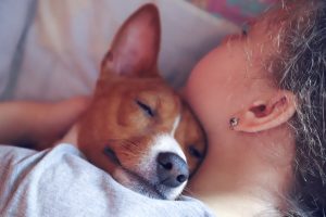 girl hugging dog