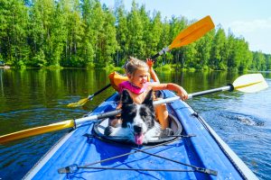 girl in boat with dog