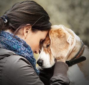 woman nuzzle dog