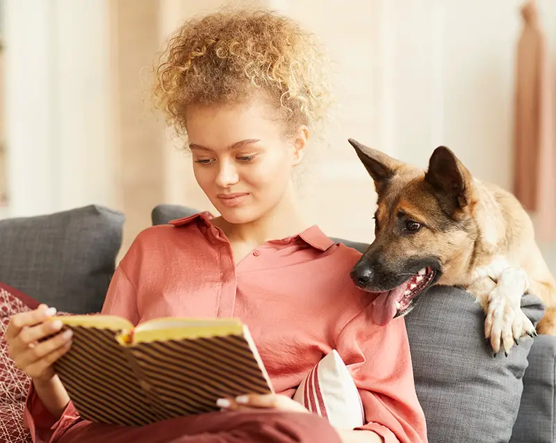 dog and woman reading